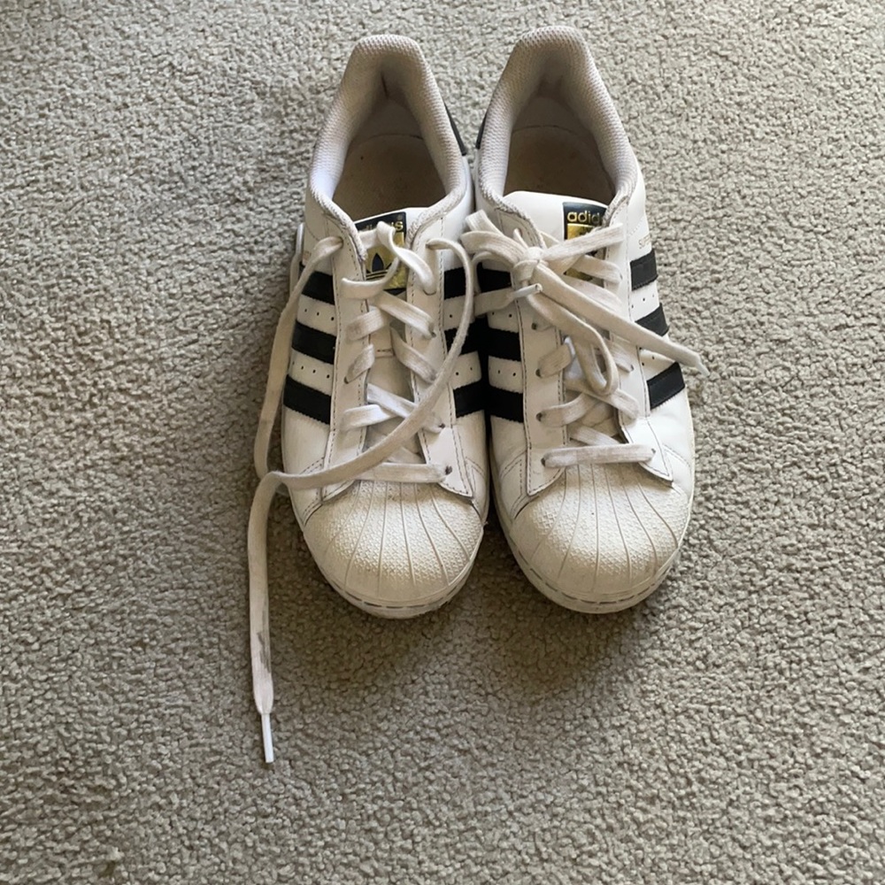 Black and white Adidas superstars